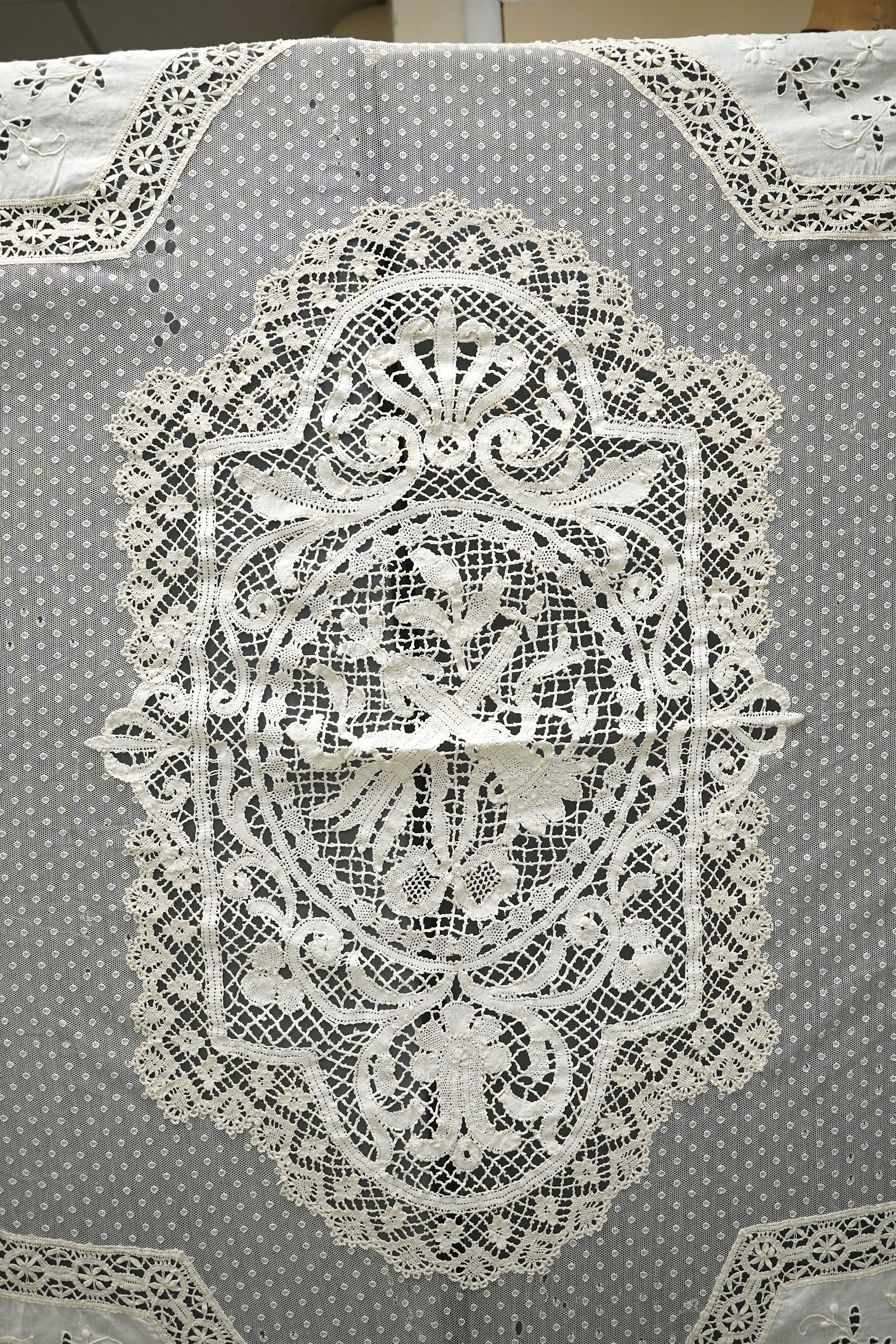 An ornate Edwardian bed cover, handmade from cut work anglaise panels, fine spot motif net and bobbin lace insertions, 228cm wide x 228 cm long. Condition - the spot motif net and fine lawn are damaged in places, the law